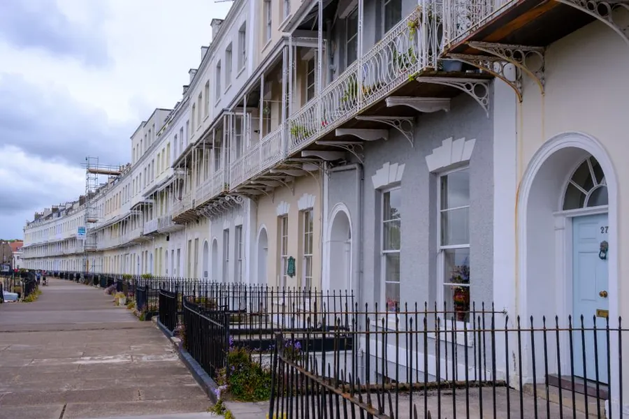 Georgian terrace with ornate cast iron balconies and original rainwater goods, comparable to Southport's Lord Street villas