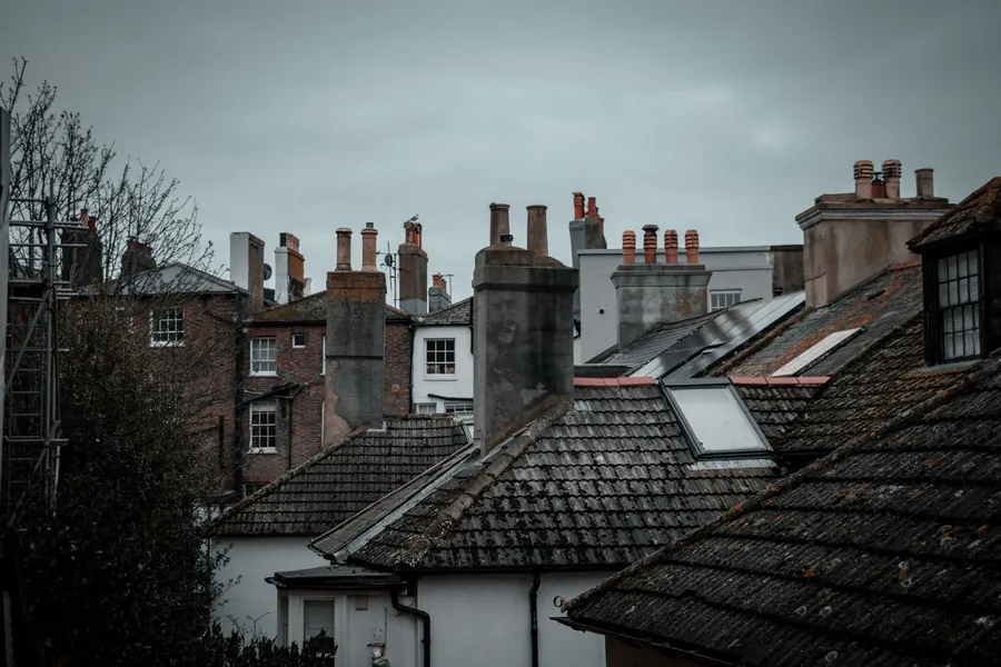 Slate rooftops and chimney stacks in a coastal English town, built without underlay and still dry