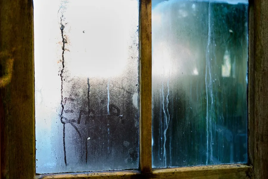 Heavy condensation on the inside of a window, the winter problem a badly built conservatory roof creates in Southport