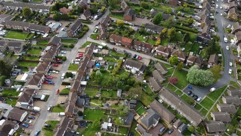 Aerial view of a British housing estate with rear extensions and garages, typical of flat roofs repaired around Southport
