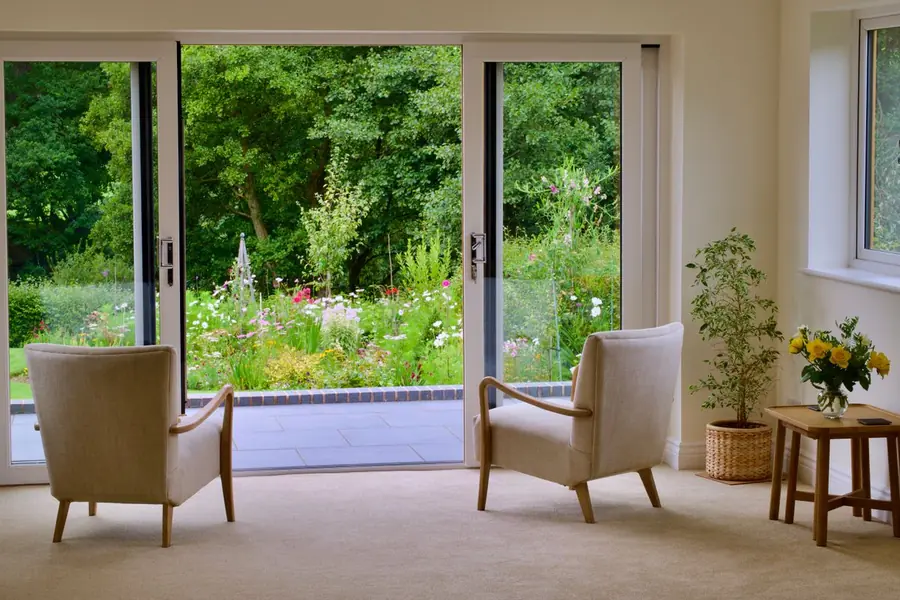 A converted garden room with a solid insulated roof and full-height garden doors on a Southport property