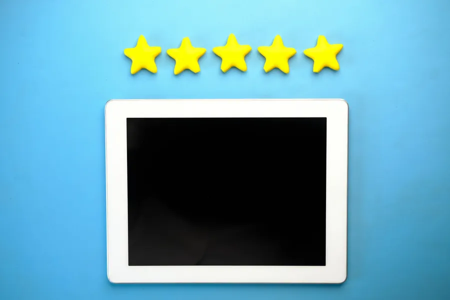 Five-star rating displayed on a tablet screen, the starting point rather than the end of checking a roofer's reviews