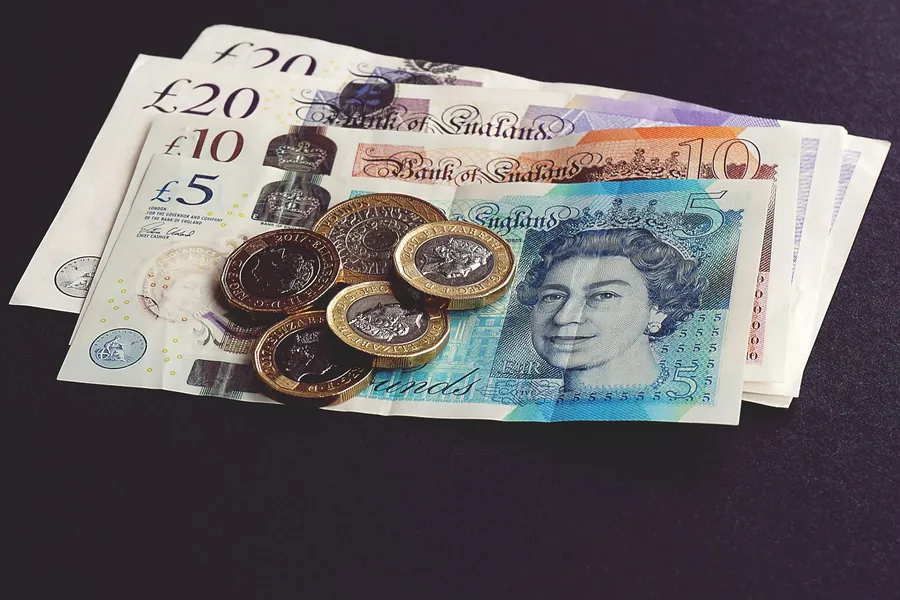 British pound notes and coins, the real budget behind a new roof in Southport
