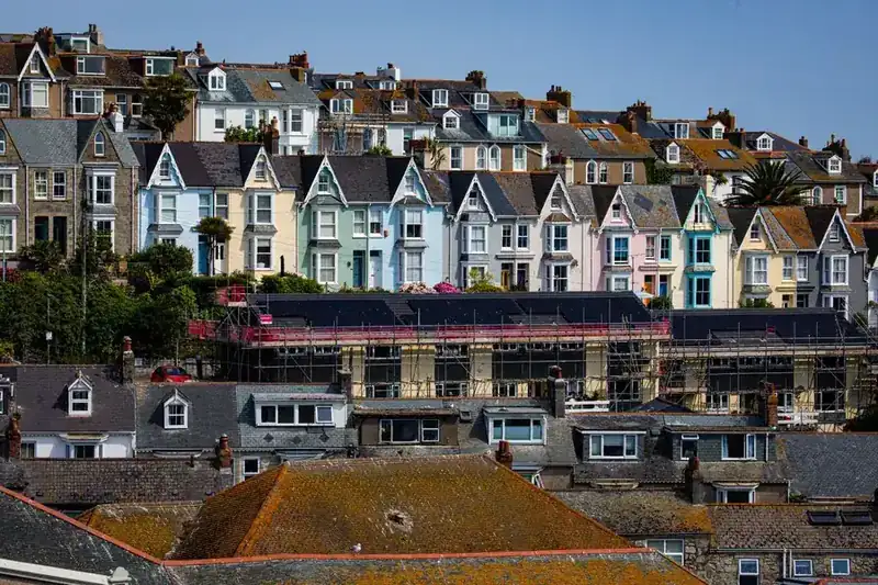 Scaffolding on terraced houses in a British seaside town, the visible sign of roof work done properly