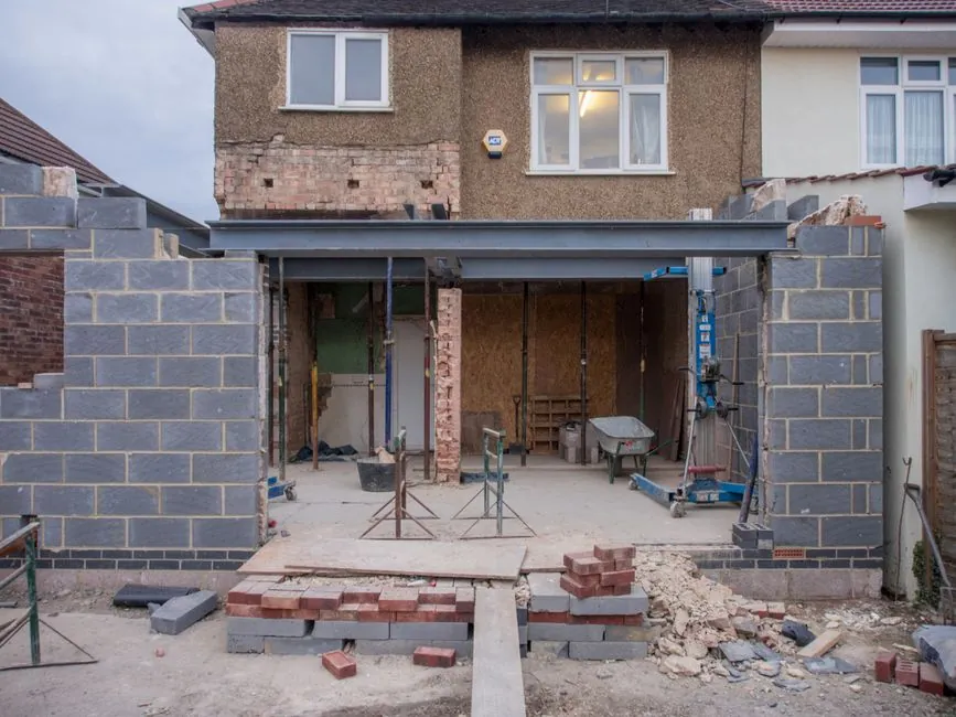 Scaffolding erected against a brick house during roof and extension work