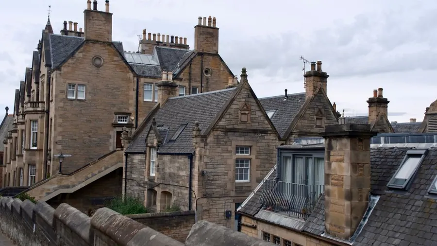 Stone rooftops with chimney stacks and parapets, the ledges gull proofing has to cover on older Southport property