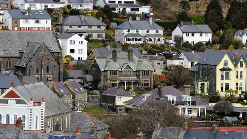 Slate roofs on a hillside town of Victorian houses, several fitted with roof windows, of the kind found across Southport