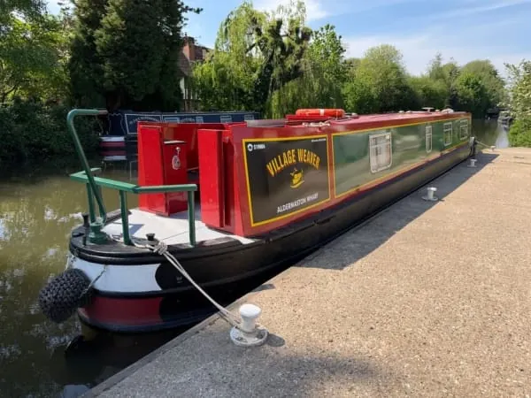 A narrowboat moored at a canal wharf, the towpath scene at the heart of Burscough