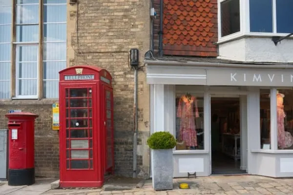 A traditional village shopfront with a red telephone box, the small-shop character of Formby village