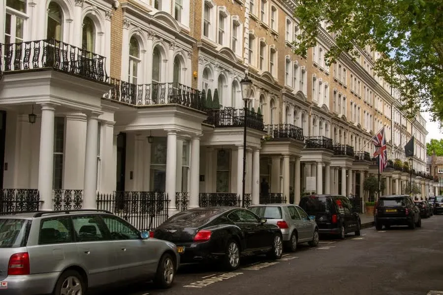 Row of bay-fronted period terraced houses with small roofs above the ground floor bays