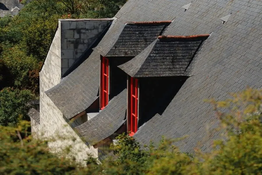 Slate roof with dormer windows showing the vertical cheeks either side of each dormer