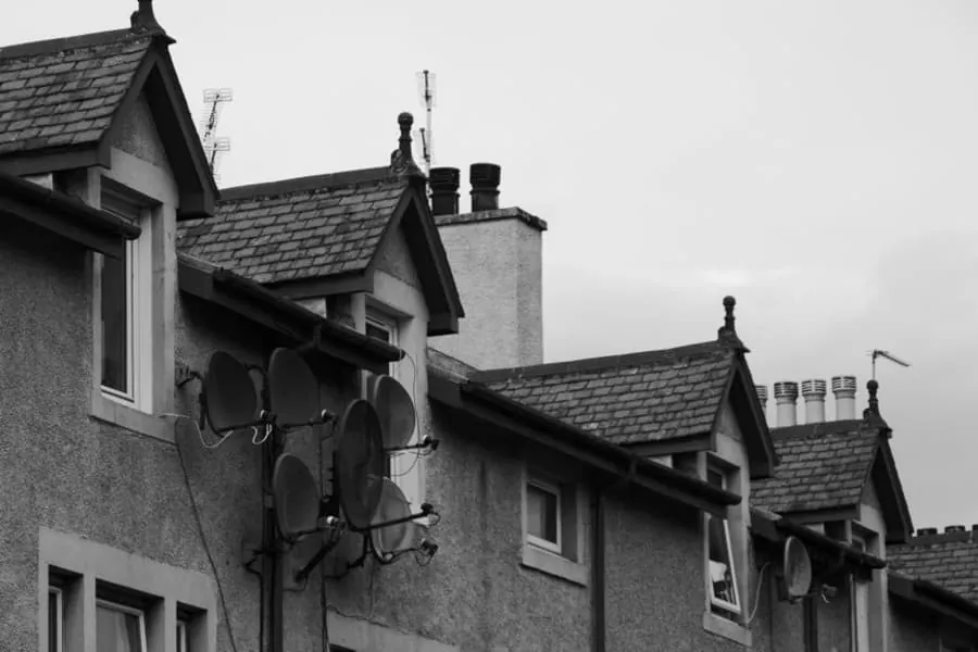 Dormer windows and chimney stacks along the roofline of a British terrace