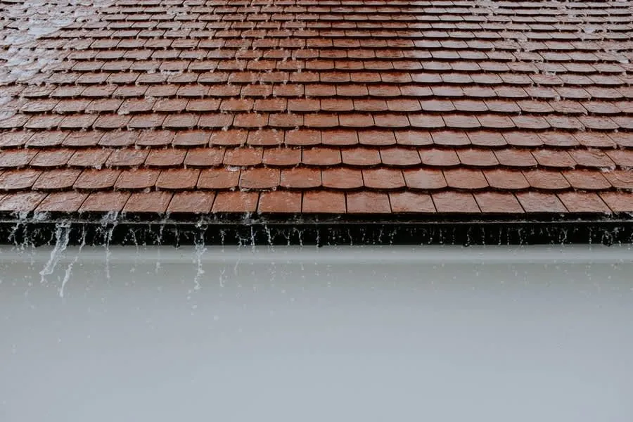 Rainwater running off roof tiles, the sort of check worth making in the first year of ownership