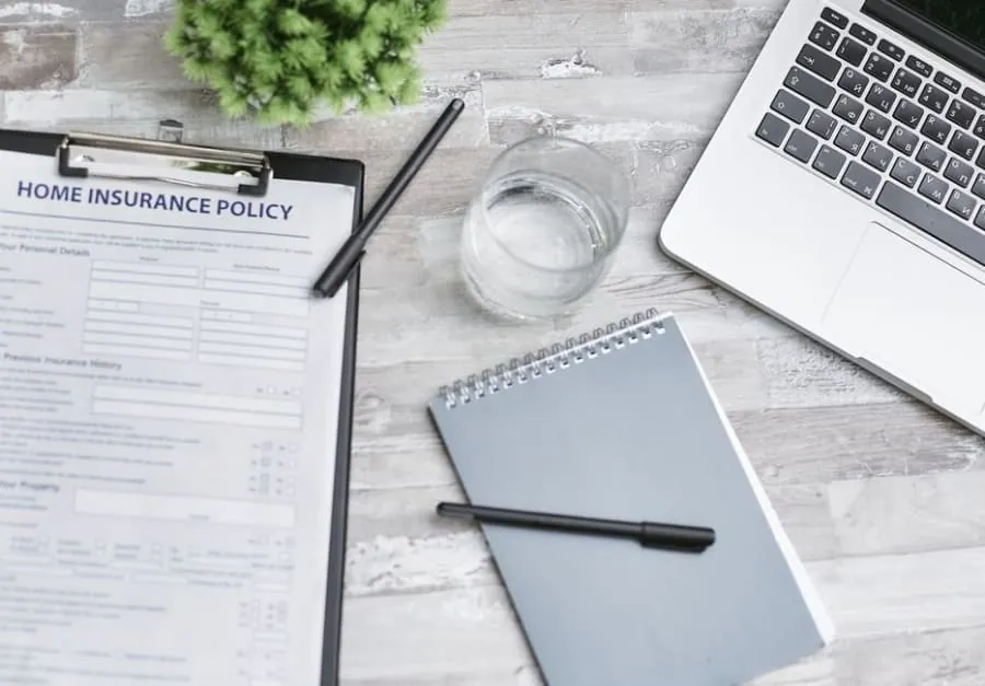A home insurance policy document on a desk