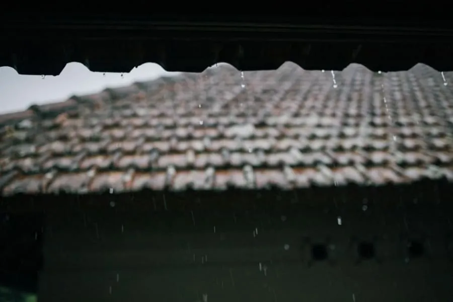 Rain running off the edge of a tiled roof