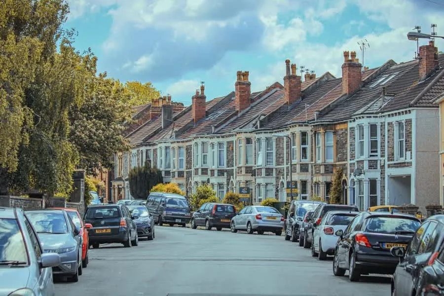 A street of British Victorian terraced houses with shared chimney stacks on the rooflines