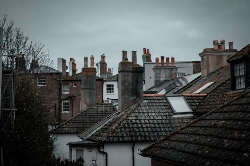 Weathered chimney stacks along old rooftops, the everyday view above Churchtown village