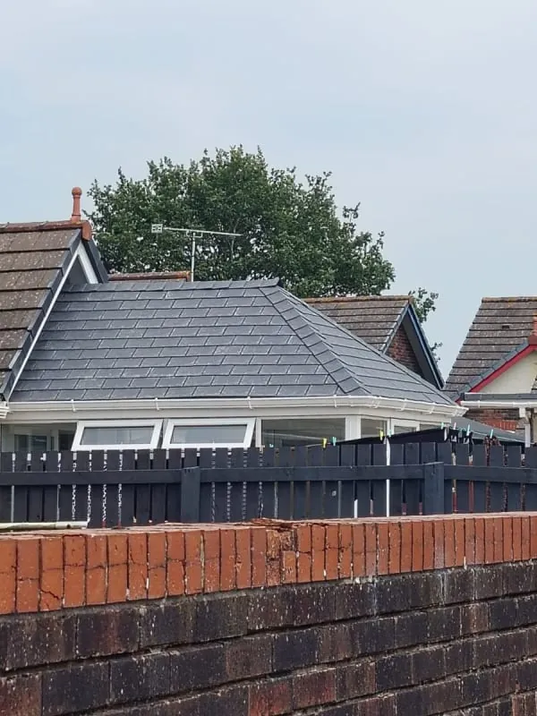 Completed hipped roof in dark slate-grey tiles on a Southport bungalow