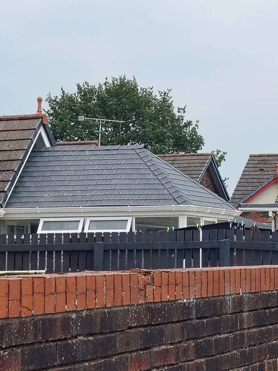 A newly slated hipped roof on a detached house, the roof shape found all over Freshfield and the larger Formby plots
