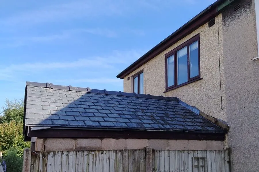 Freshly laid natural slate with new lead flashing against a chimney, the kind of inland roof work common across Ormskirk and Burscough